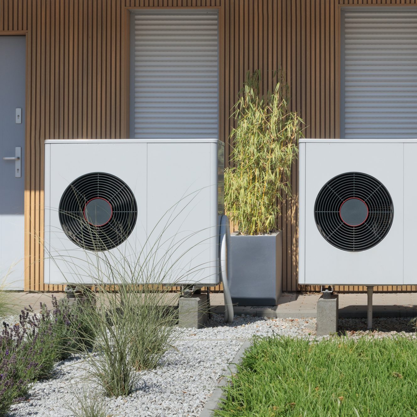 A pair of air source heat pumps, an eco-friendly home heating solution, installed at a contemporary residential property